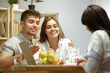 Image showing Smiling nutritionist showing a healthy diet plan to patient