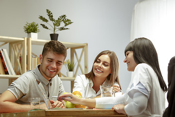 Image showing Smiling nutritionist showing a healthy diet plan to patient