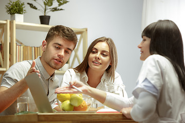 Image showing Smiling nutritionist showing a healthy diet plan to patient