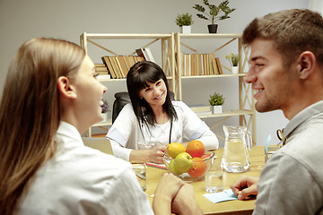 Image showing Smiling nutritionist showing a healthy diet plan to patient