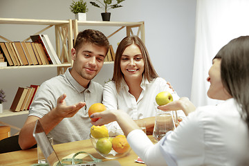 Image showing Smiling nutritionist showing a healthy diet plan to patient