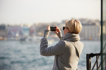 Image showing Pretty blonde taking a selfie on a spring day