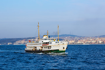 Image showing Tourist boat sails on the Golden Horn in Istanbul at sunset, Turkey.