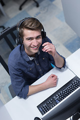 Image showing male call centre operator doing his job top view