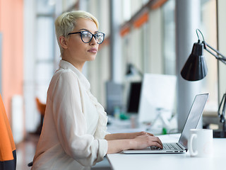 Image showing businesswoman using a laptop in startup office