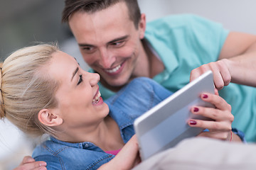 Image showing couple relaxing at  home with tablet computers