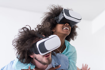 Image showing multiethnic couple getting experience using VR headset glasses