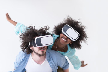 Image showing multiethnic couple getting experience using VR headset glasses