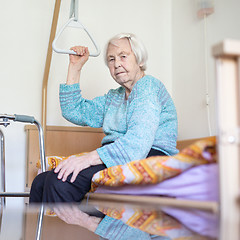 Image showing Elderly 96 years old woman sitting on medical bed in hospic.