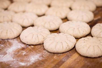 Image showing balls of dough bread getting ready to be baked