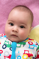 Image showing top view of newborn baby boy lying on colorful blankets