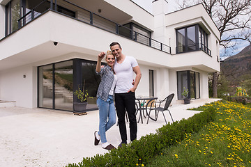 Image showing couple hugging in front of  new luxury home