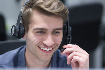 Image showing male call centre operator doing his job