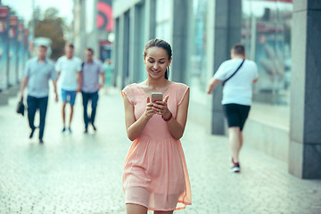 Image showing Young Beautiful Woman Talking On Mobile Phone Outdoor.