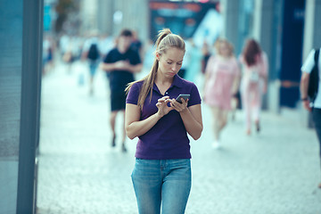 Image showing Young Beautiful Woman Talking On Mobile Phone Outdoor.
