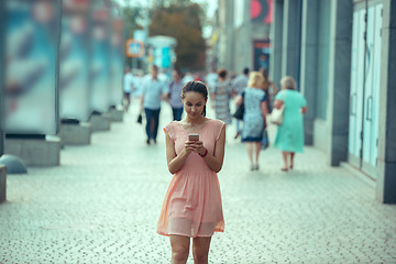 Image showing Young Beautiful Woman Talking On Mobile Phone Outdoor.