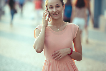 Image showing Young Beautiful Woman Talking On Mobile Phone Outdoor.