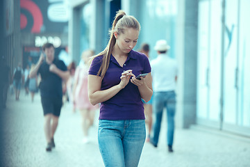 Image showing Young Beautiful Woman Talking On Mobile Phone Outdoor.