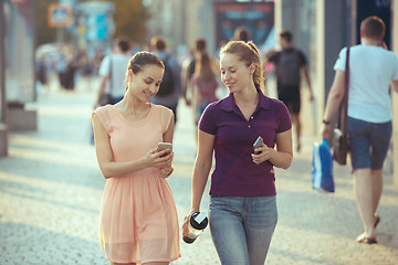 Image showing Young Beautiful Women Talking On Mobile Phone Outdoor.