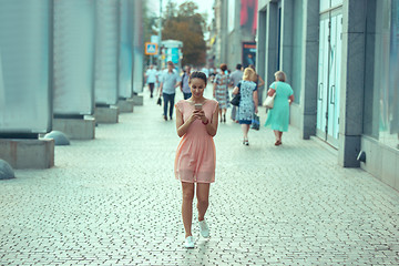 Image showing Young Beautiful Woman Talking On Mobile Phone Outdoor.