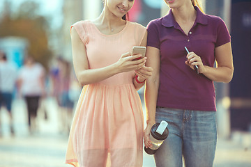 Image showing Young Beautiful Women Talking On Mobile Phone Outdoor.