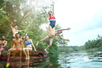 Image showing Enjoying river party with friends. Group of beautiful happy young people at the river together