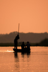 Image showing Blurred Men in a boat on a river silhouette