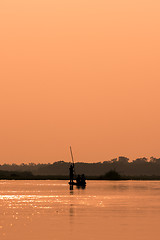 Image showing Men in a boat on a river silhouette