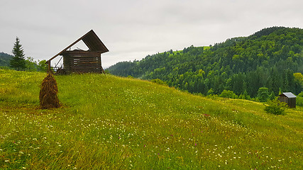 Image showing Mountain huts on green hill