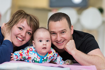 Image showing Portrait of young happy couple with their adorable baby boy