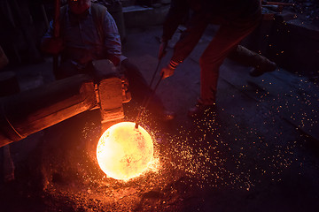 Image showing blacksmith workers using mechanical hammer at workshop