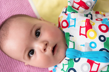 Image showing top view of newborn baby boy lying on colorful blankets