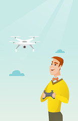 Image showing Young caucasian man flying drone.