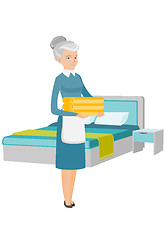 Image showing Caucasian housekeeping maid with stack of linen.