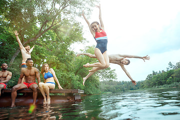 Image showing Enjoying river party with friends. Group of beautiful happy young people at the river together