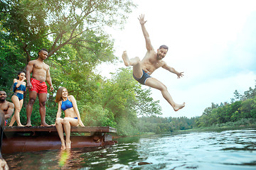 Image showing Enjoying river party with friends. Group of beautiful happy young people at the river together