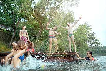 Image showing Enjoying river party with friends. Group of beautiful happy young people at the river together