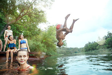 Image showing Enjoying river party with friends. Group of beautiful happy young people at the river together