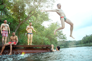 Image showing Enjoying river party with friends. Group of beautiful happy young people at the river together