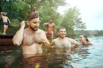 Image showing Enjoying river party with friends. Group of beautiful happy young people at the river together