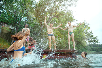 Image showing Enjoying river party with friends. Group of beautiful happy young people at the river together