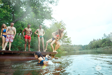 Image showing Enjoying river party with friends. Group of beautiful happy young people at the river together