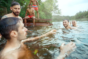 Image showing Enjoying river party with friends. Group of beautiful happy young people at the river together