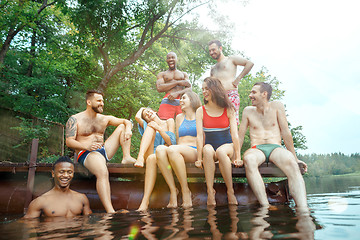 Image showing Enjoying river party with friends. Group of beautiful happy young people at the river together