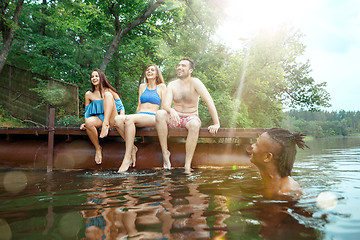 Image showing Enjoying river party with friends. Group of beautiful happy young people at the river together