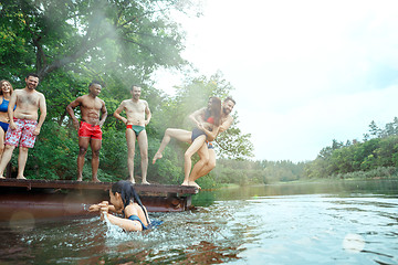 Image showing Enjoying river party with friends. Group of beautiful happy young people at the river together