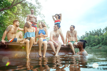 Image showing Enjoying river party with friends. Group of beautiful happy young people at the river together