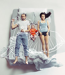 Image showing Top view of happy family with one newborn child in bedroom and their dreams .