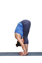 Image showing Woman doing yoga asana Uttanasana - standing forward bend