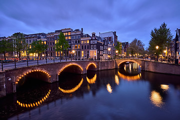 Image showing Amterdam canal, bridge and medieval houses in the evening